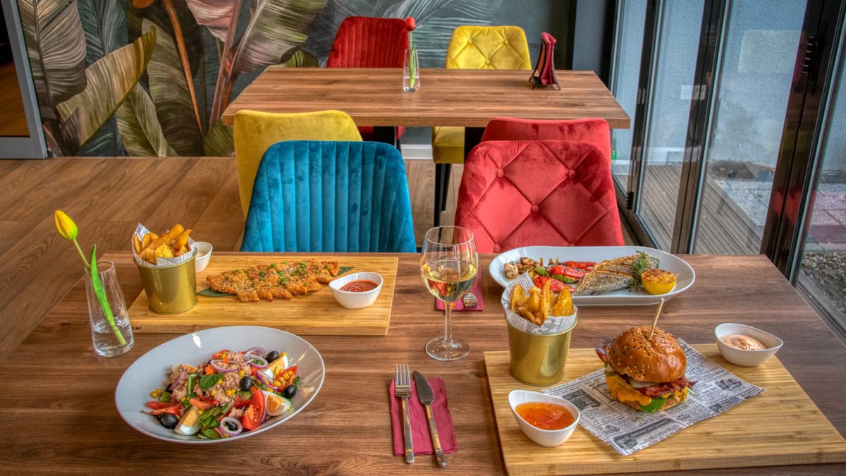 Colorful dining setup in a modern restaurant featuring diverse meals and vivid decor.